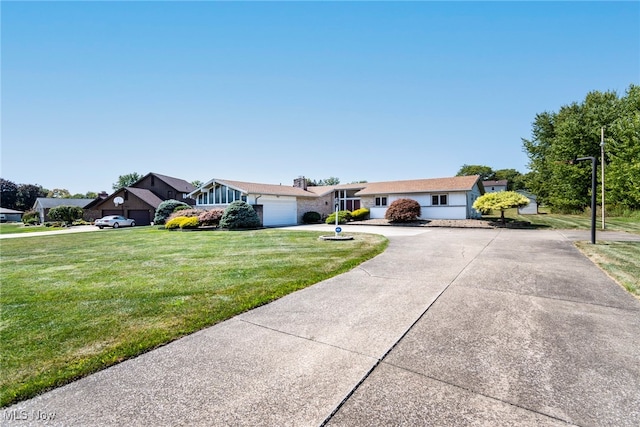 ranch-style house featuring a garage and a front yard