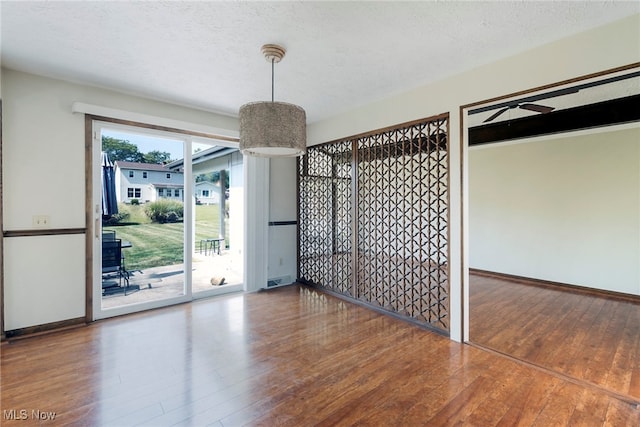 spare room with dark wood-type flooring and a textured ceiling