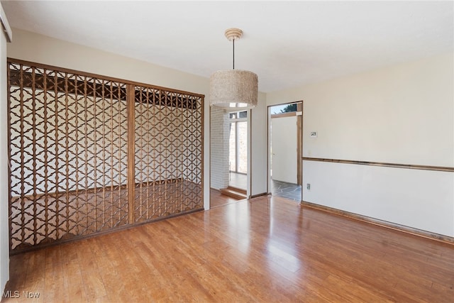 unfurnished room with wood-type flooring