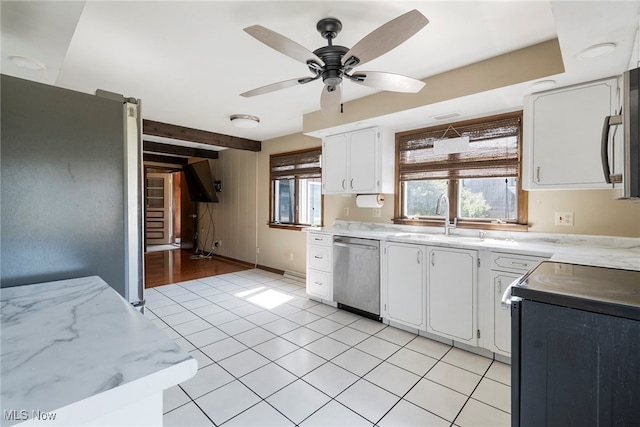 kitchen featuring a wealth of natural light, stainless steel appliances, ceiling fan, and white cabinets