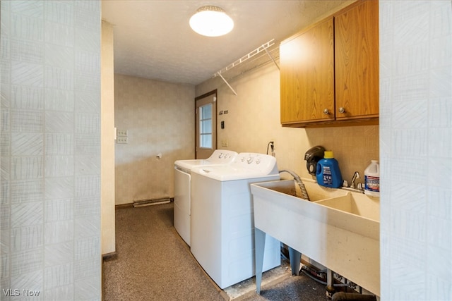 laundry room with independent washer and dryer, cabinets, and sink