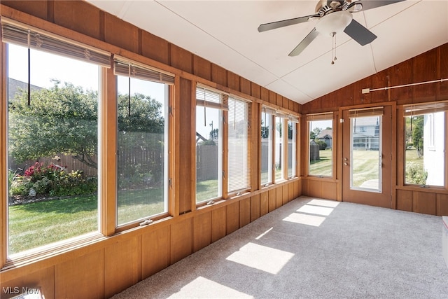 unfurnished sunroom with lofted ceiling, ceiling fan, and a wealth of natural light