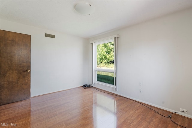 unfurnished room featuring hardwood / wood-style flooring