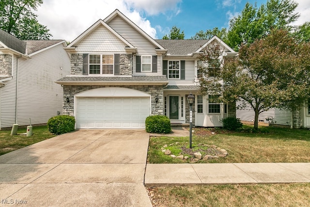 view of front of property featuring a garage and a front yard