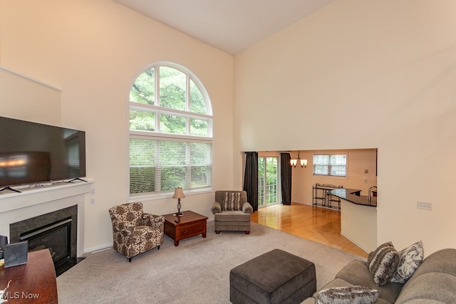 living room with high vaulted ceiling, a wealth of natural light, and light hardwood / wood-style floors