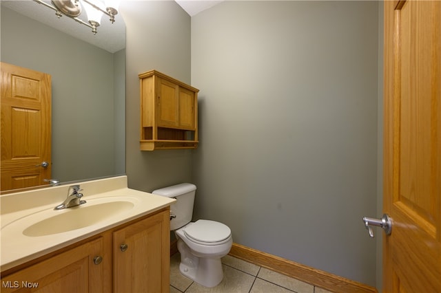 bathroom featuring tile patterned floors, toilet, and vanity