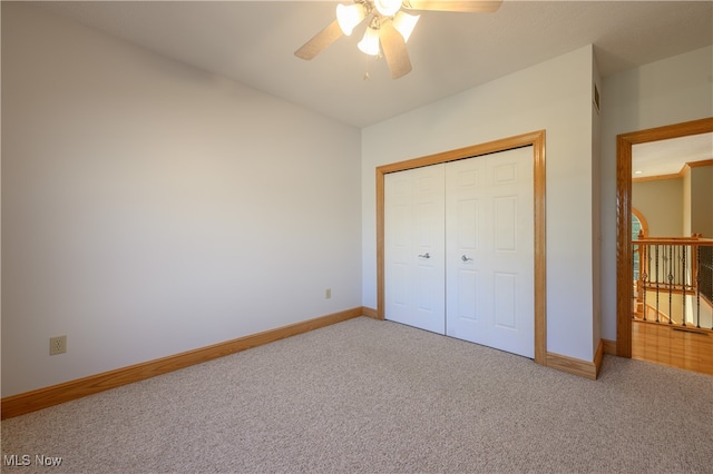 unfurnished bedroom featuring a closet, carpet flooring, and ceiling fan