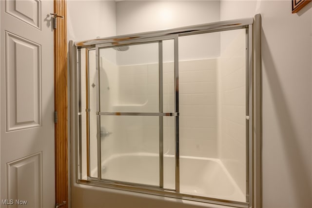 bathroom with shower / bath combination with glass door