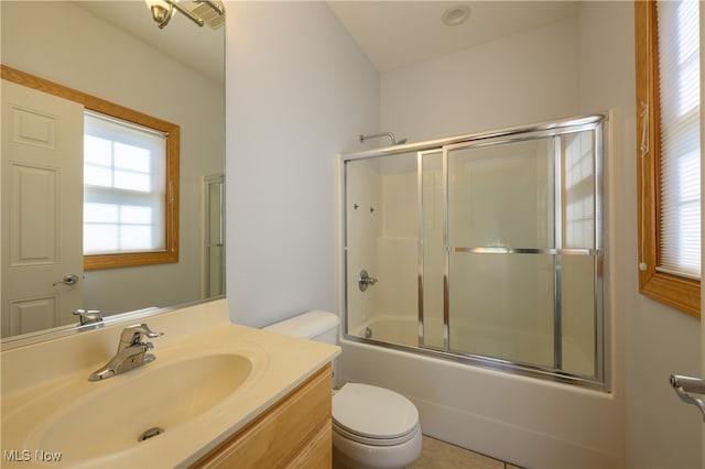 full bathroom with vanity, toilet, and enclosed tub / shower combo