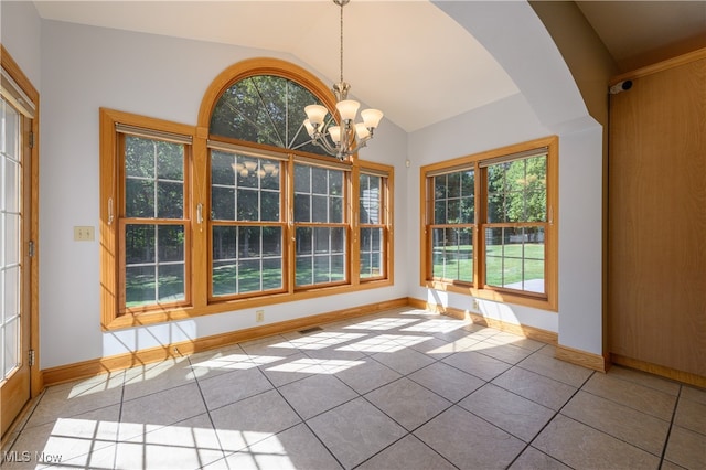 unfurnished dining area featuring vaulted ceiling, a chandelier, and light tile patterned flooring