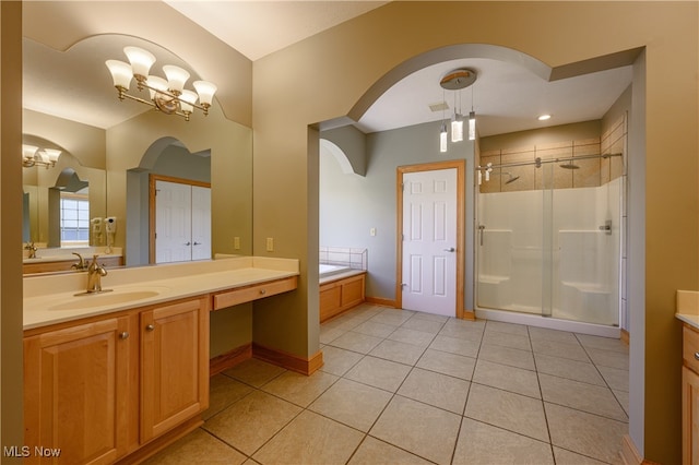 bathroom featuring vanity, independent shower and bath, a notable chandelier, and tile patterned flooring