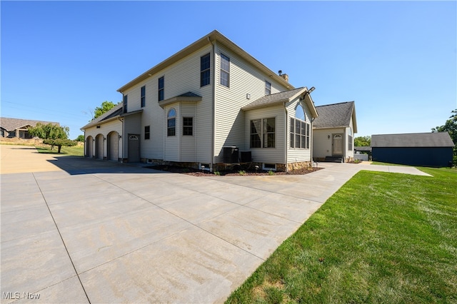 view of side of home with a yard and a garage