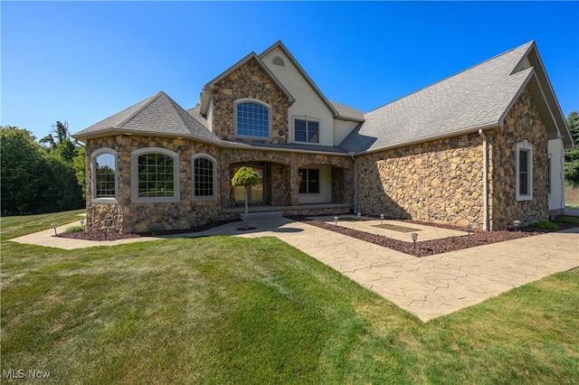 view of front facade with a front yard and a patio