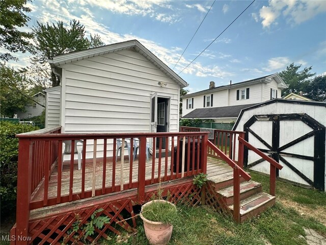 wooden deck featuring a storage unit