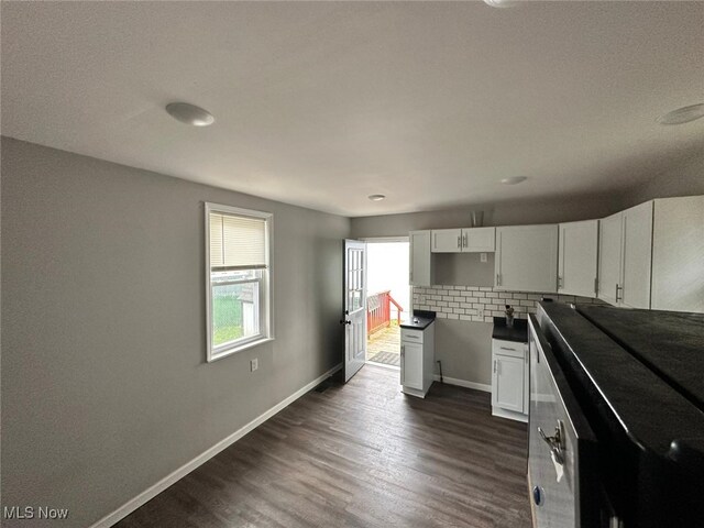 kitchen with white cabinets, dark wood-type flooring, and decorative backsplash