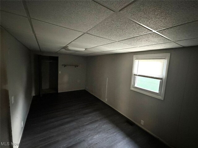 unfurnished room featuring a paneled ceiling and wood-type flooring