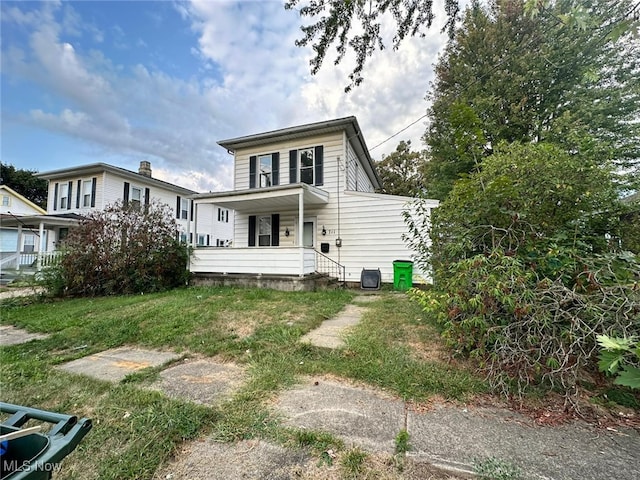 back of property featuring covered porch