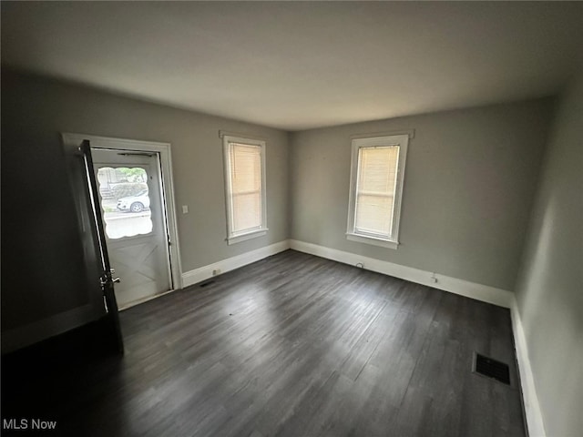 spare room with dark hardwood / wood-style floors