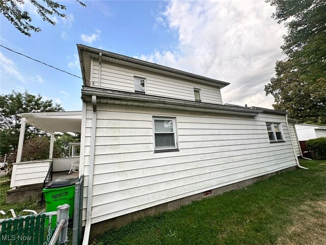 view of property exterior featuring a lawn