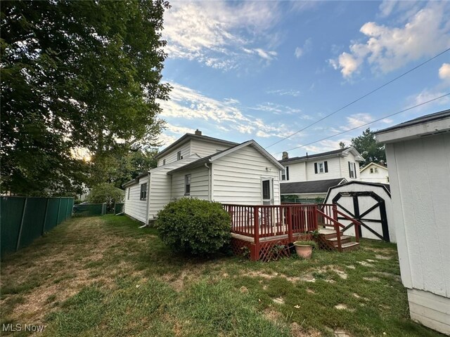 view of yard with a storage shed and a deck