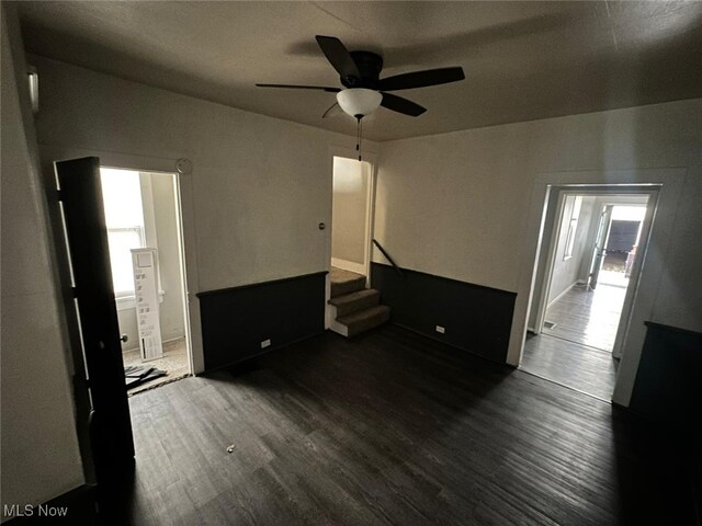 unfurnished bedroom with ceiling fan and dark hardwood / wood-style flooring