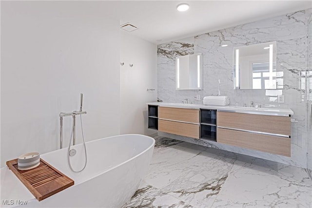 bathroom with vanity and a washtub