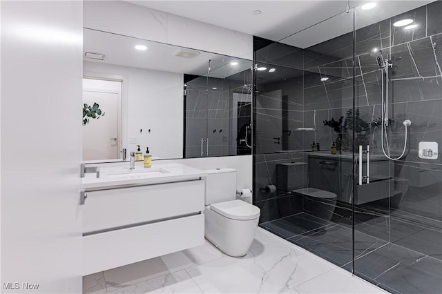 bathroom featuring a shower with door, vanity, and toilet