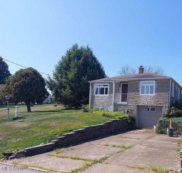 view of front of house with a garage and a front yard