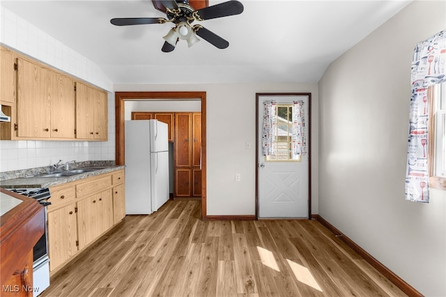 kitchen with white refrigerator, stainless steel range oven, light hardwood / wood-style floors, sink, and ceiling fan