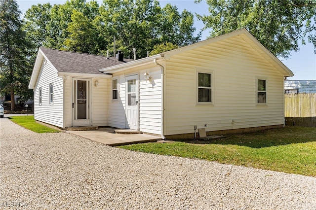 back of property featuring a lawn