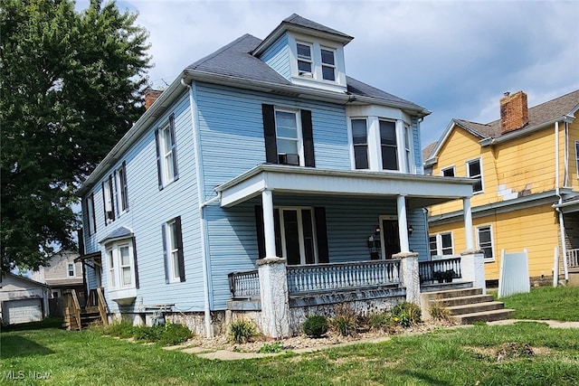 view of front of property with a porch and a front yard