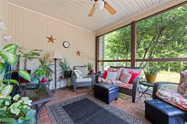 sunroom featuring ceiling fan