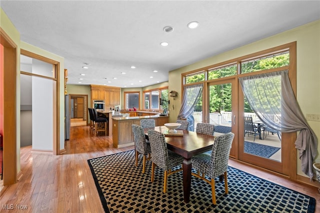 dining area featuring a wealth of natural light and light hardwood / wood-style floors