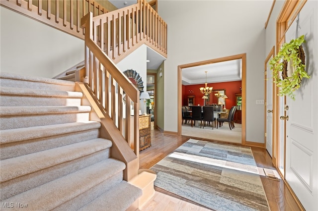 entrance foyer with ornamental molding and wood-type flooring