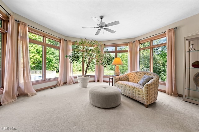 sitting room featuring a healthy amount of sunlight, ceiling fan, and carpet flooring