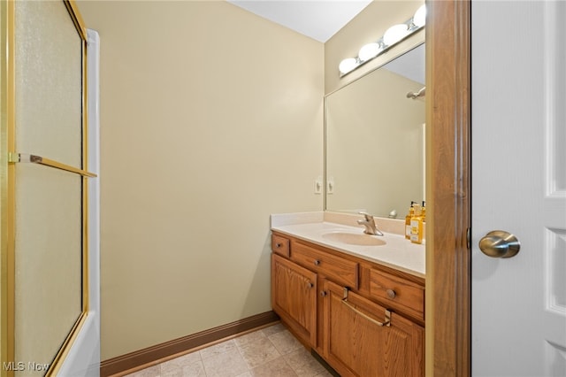 bathroom with vanity, bath / shower combo with glass door, and tile patterned floors