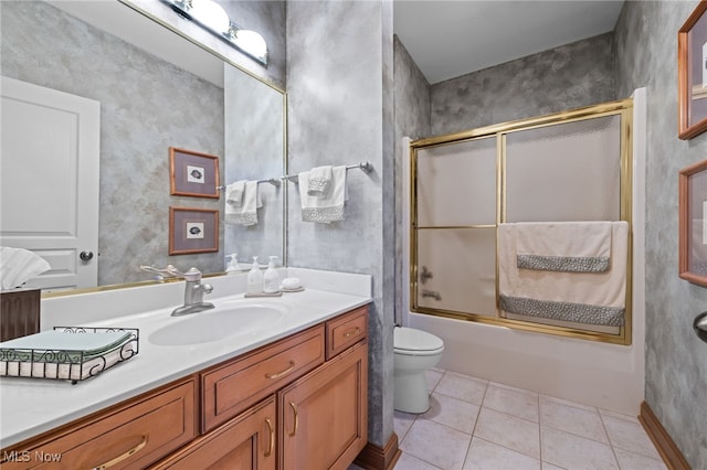 full bathroom with shower / bath combination with glass door, vanity, toilet, and tile patterned floors