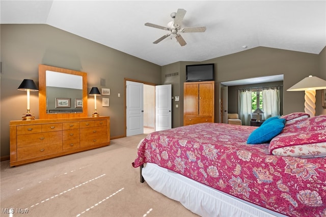 bedroom with lofted ceiling, ceiling fan, and light carpet