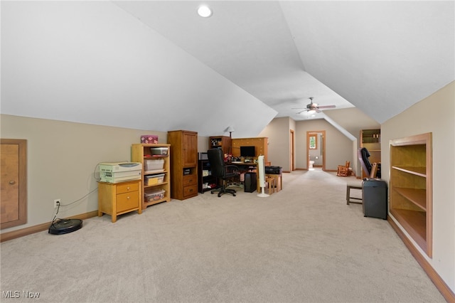 office with lofted ceiling, built in features, ceiling fan, and light carpet