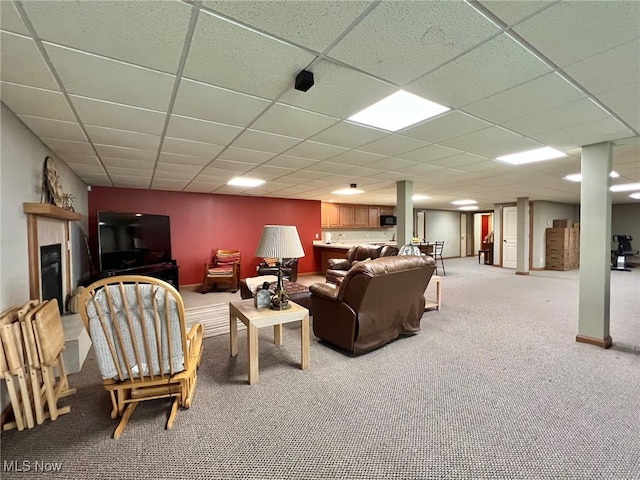 living room with a paneled ceiling and carpet floors