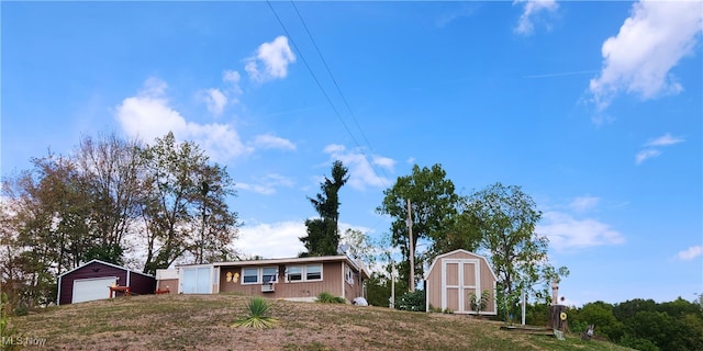 view of front of property featuring a shed