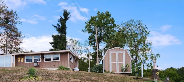 view of front of home featuring a storage unit