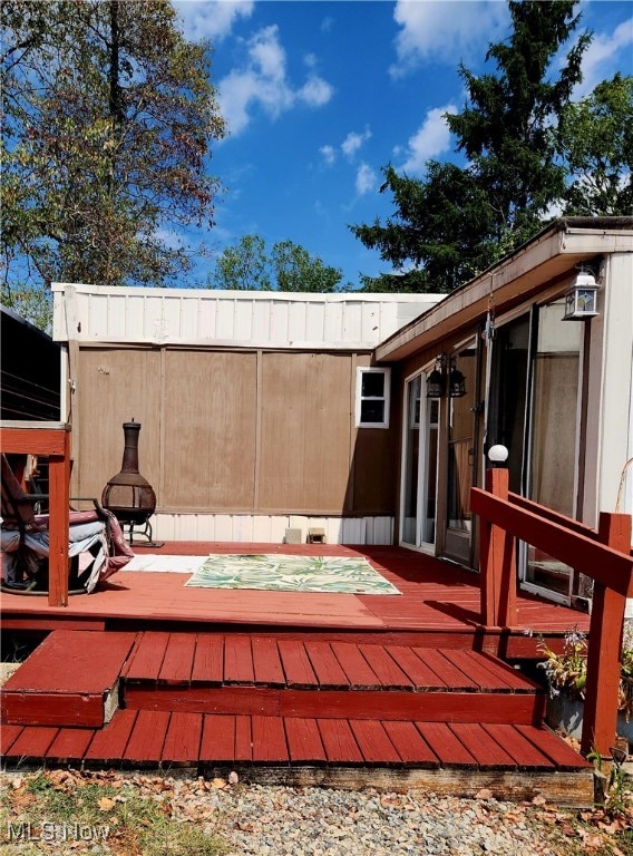 view of patio featuring a jacuzzi and a wooden deck