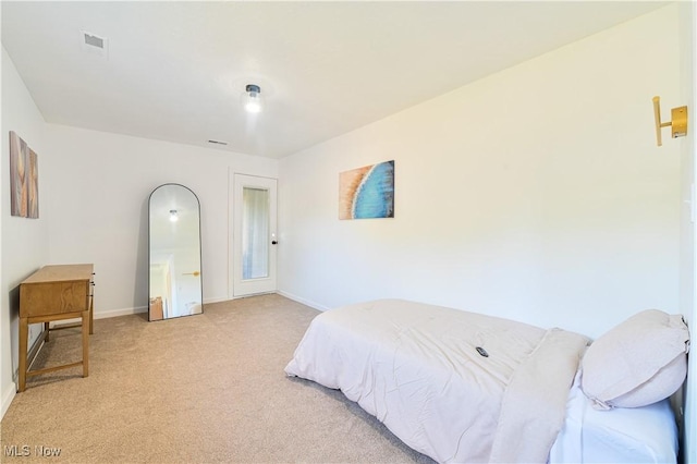 bedroom featuring light colored carpet