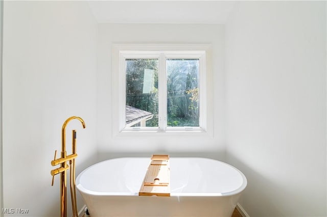 bathroom featuring a tub to relax in