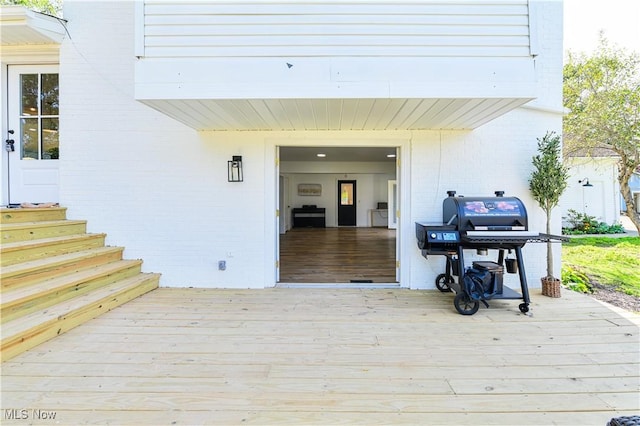 view of exterior entry with a deck