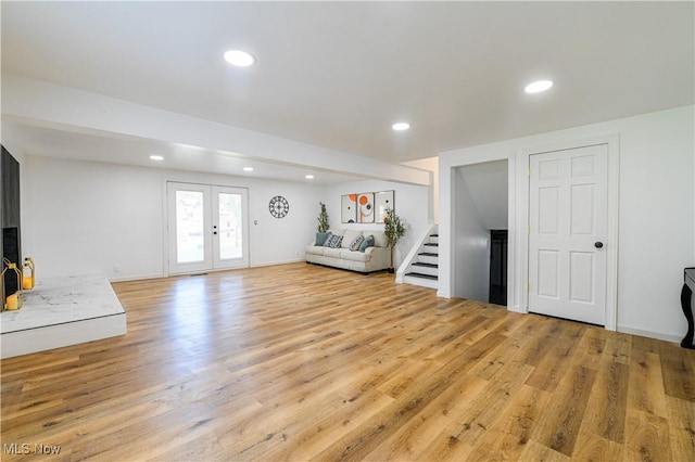 unfurnished living room with french doors and light hardwood / wood-style floors