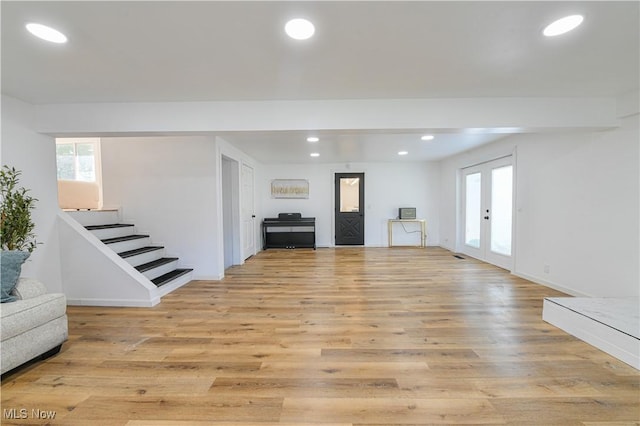 living room featuring light hardwood / wood-style flooring and french doors