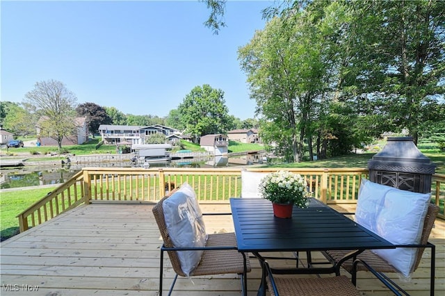 wooden terrace with a lawn