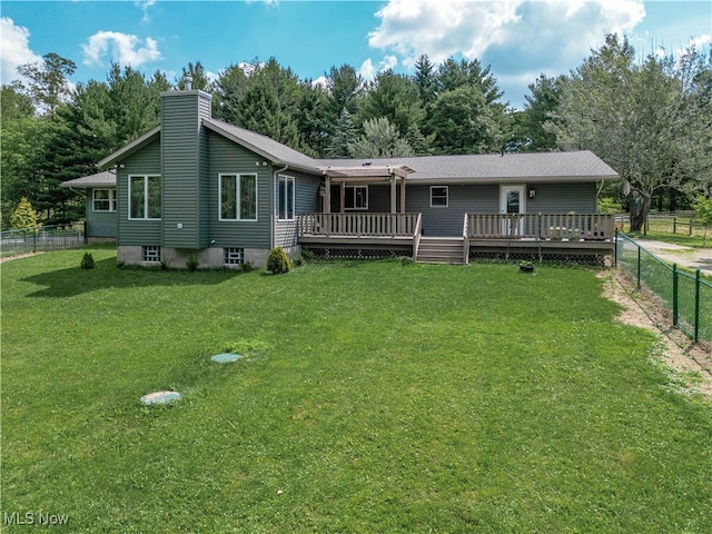 rear view of property with a yard and a deck